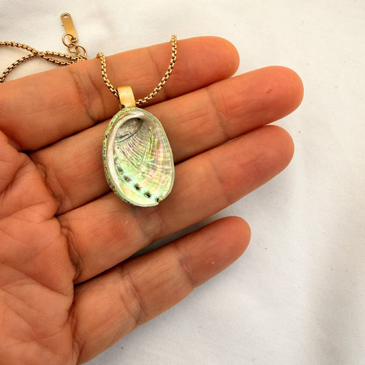 Paua shell pendant necklace close-up showing beachsand stone setting