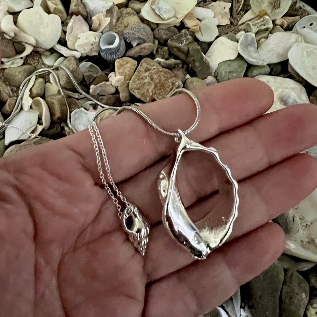 These necklaces showcasing broken sea snail shells (whelk & trumpet)