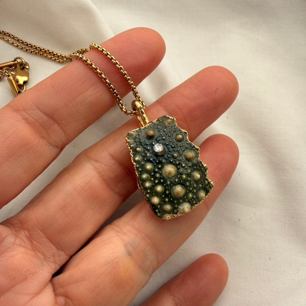 Broken kina shell fragment necklace styled on model