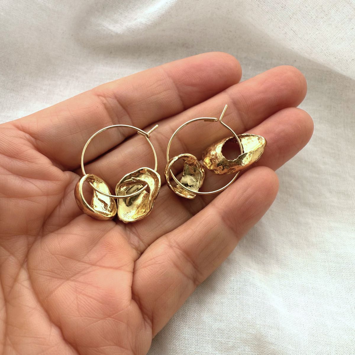 Beachcombed broken shell hoop earrings worn on model