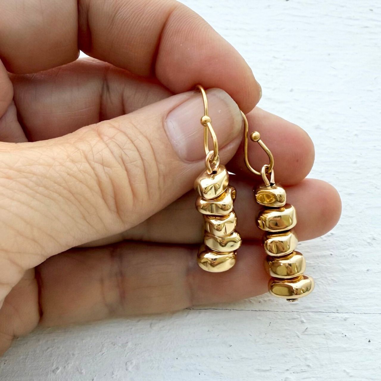 Cairn stone stack earrings worn on model