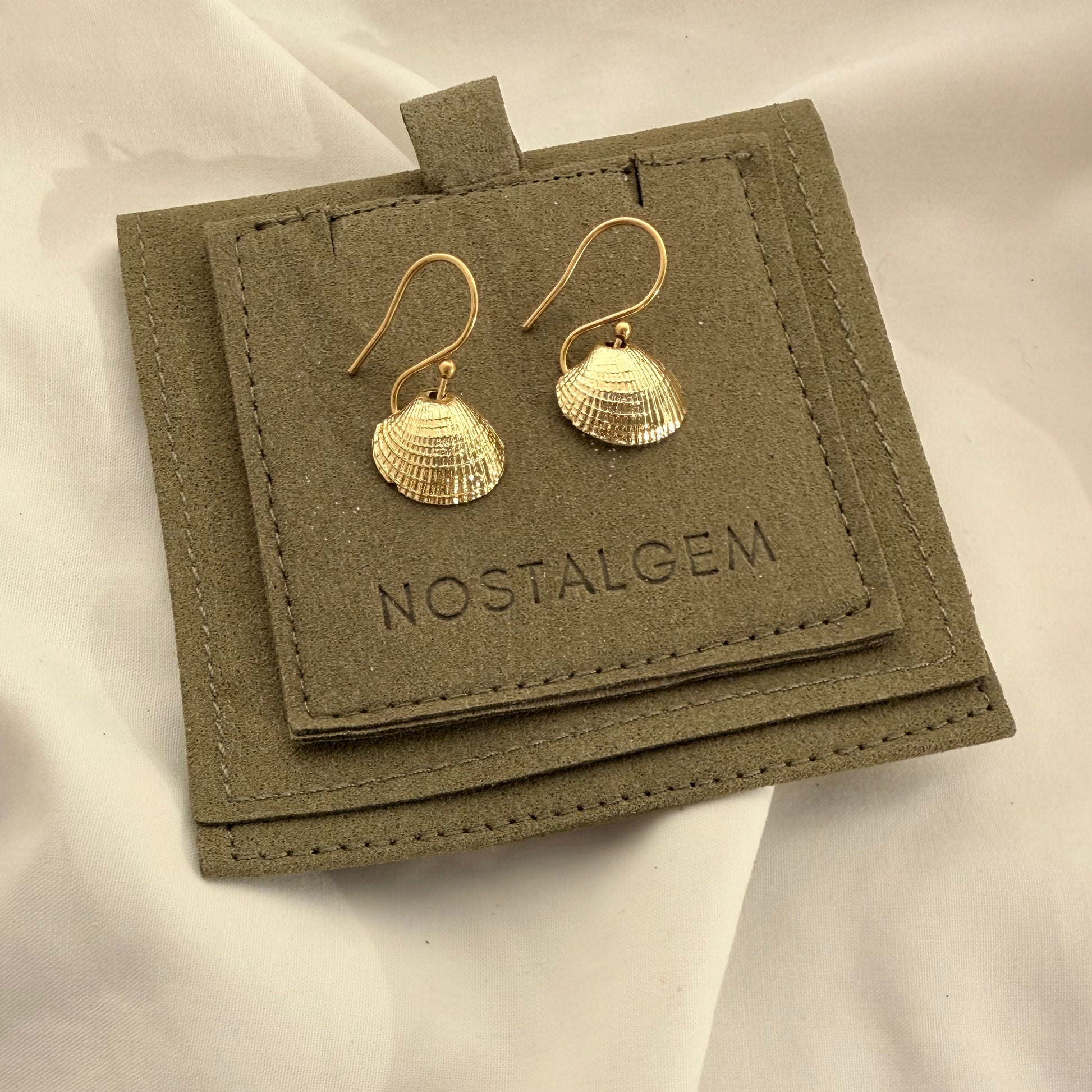 Cockle shell hook earrings styled on model
