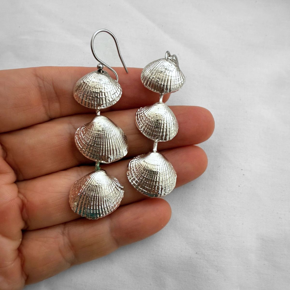 Cockle shell drop earrings worn on model