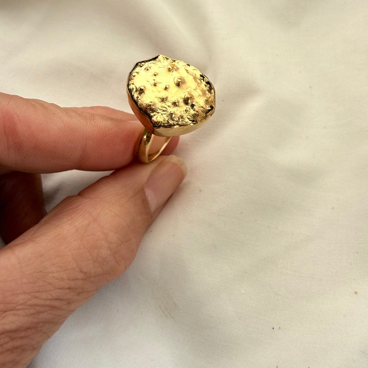 Broken kina shell fragment ring worn on hand