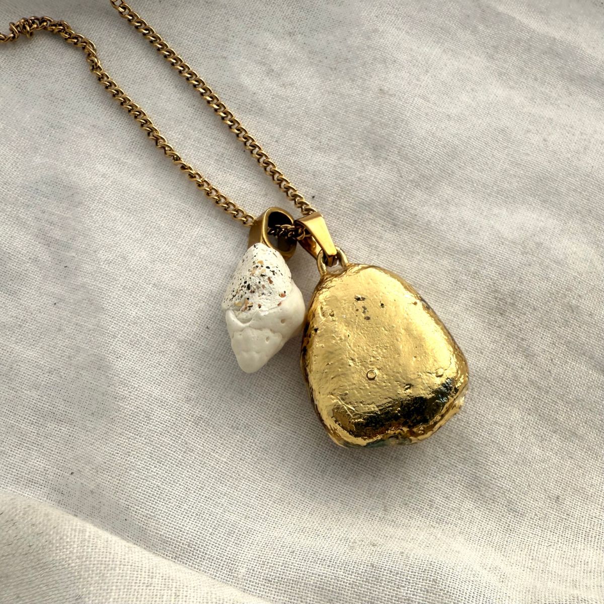 Broken kina and whelk shell necklace worn on model