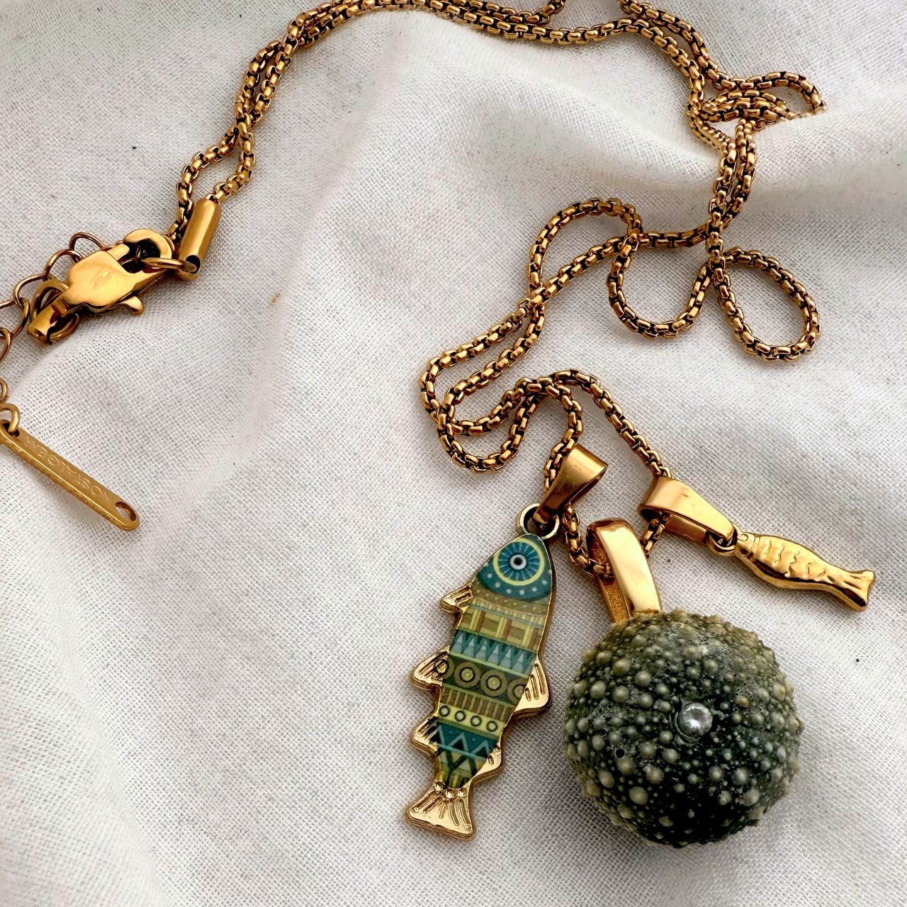 Tides and Tales necklace kina and fish catch charms, handmade New Zealand jewellery