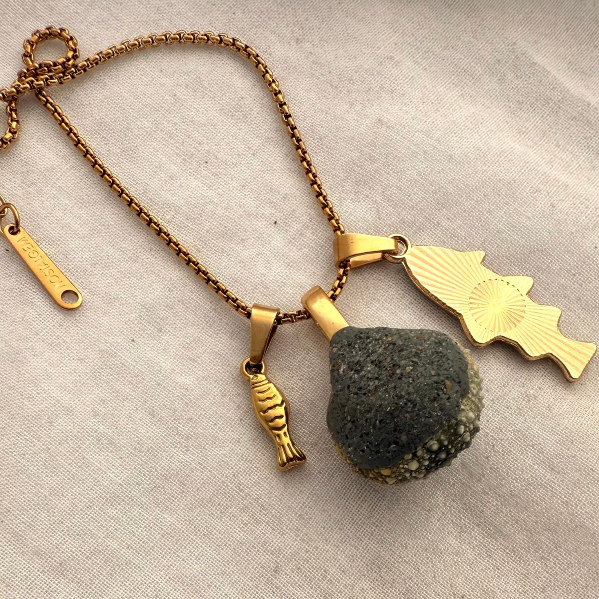Kina and fish charm necklace styled shot