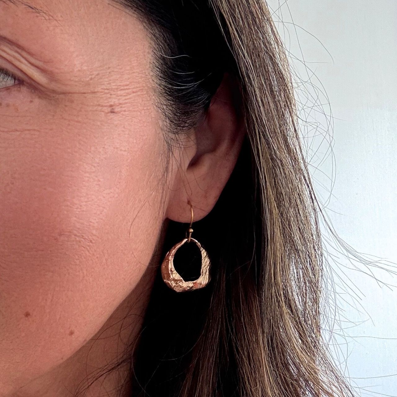 Broken oyster shell earrings, natural hole detail