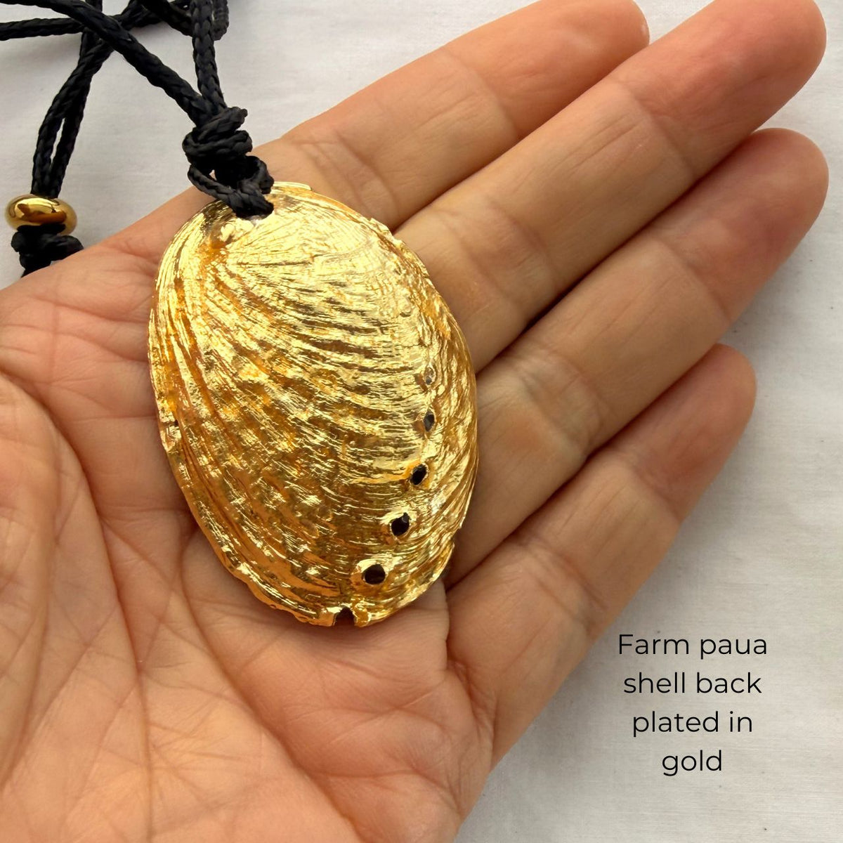 Paua shell cord necklace worn on model