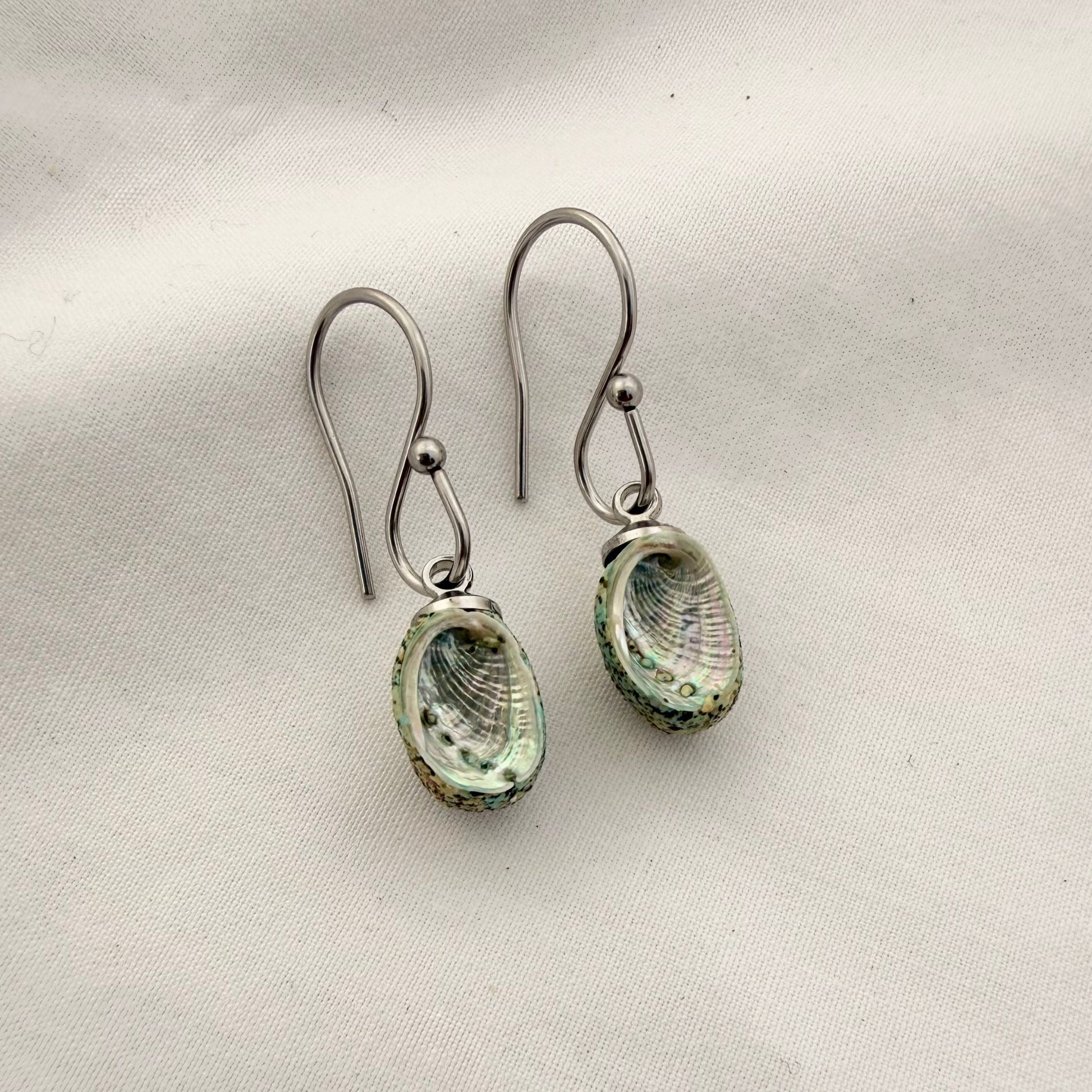 Paua shell dangle hook earrings worn, handmade New Zealand jewellery