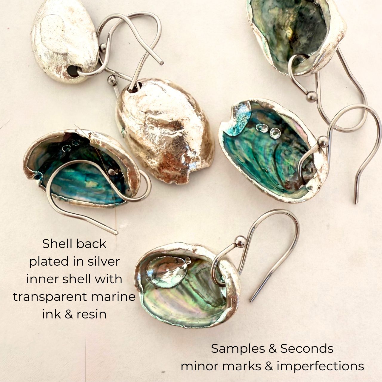 Paua shell hook earrings worn on model