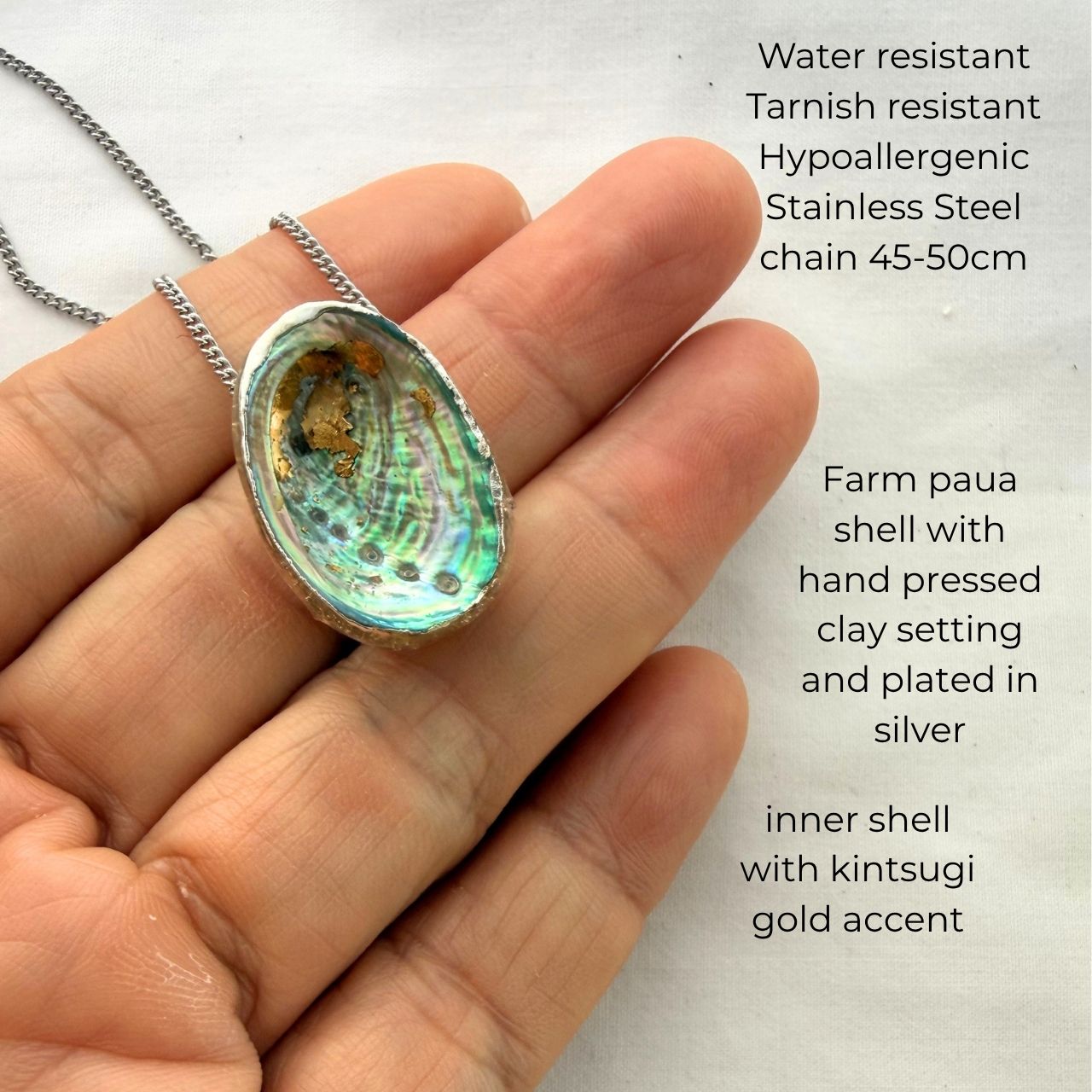 Silver paua shell floating necklace worn on model