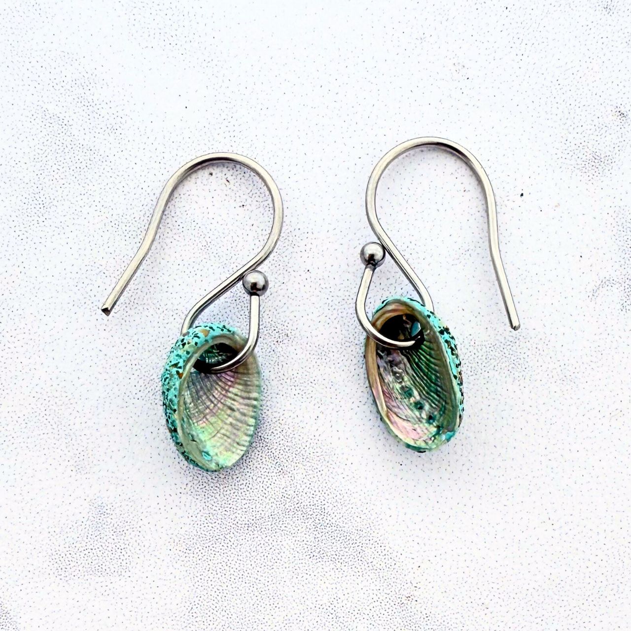 Paua shell beachsand stone hook earrings worn on model