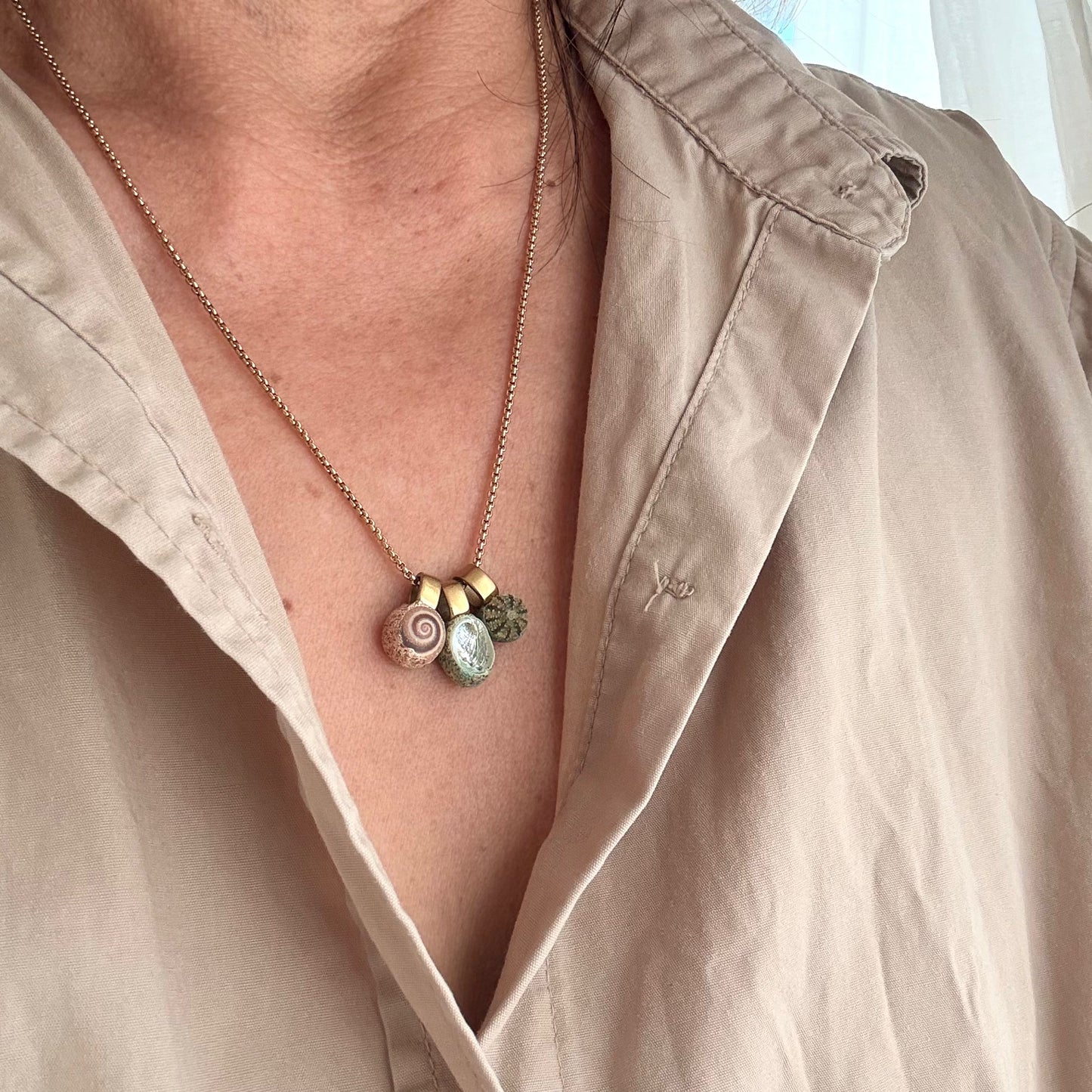 Paua wheel and kina shell trio necklace close-up detail
