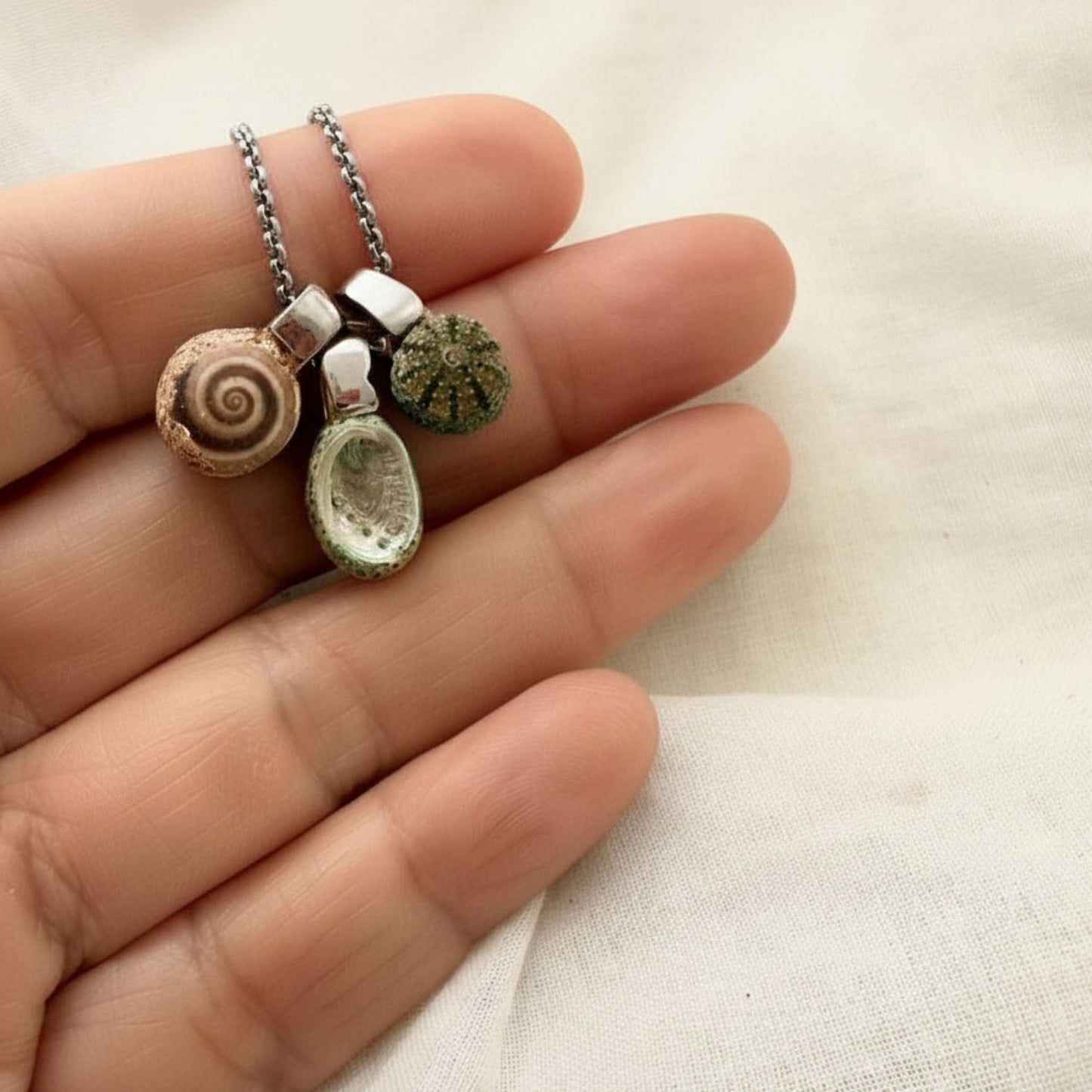 Paua wheel and kina shell trio necklace worn on model