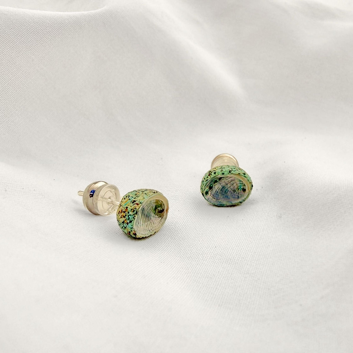 Paua shell stud earrings worn, handmade New Zealand jewellery