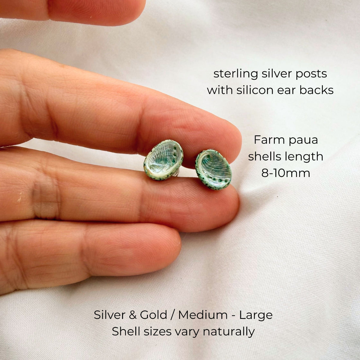 Paua shell stud earrings styled on model
