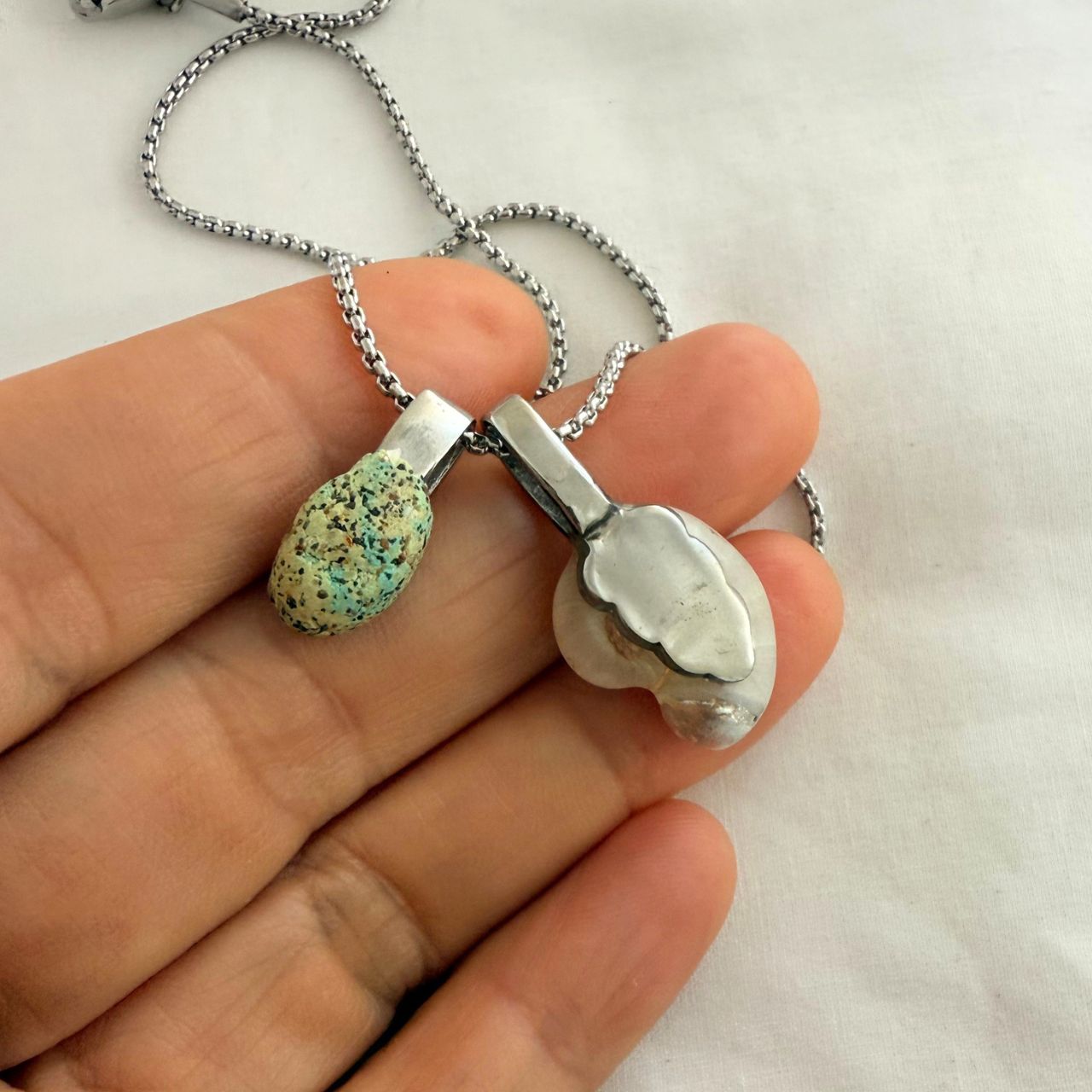 Ram's horn squid and paua necklace worn on model