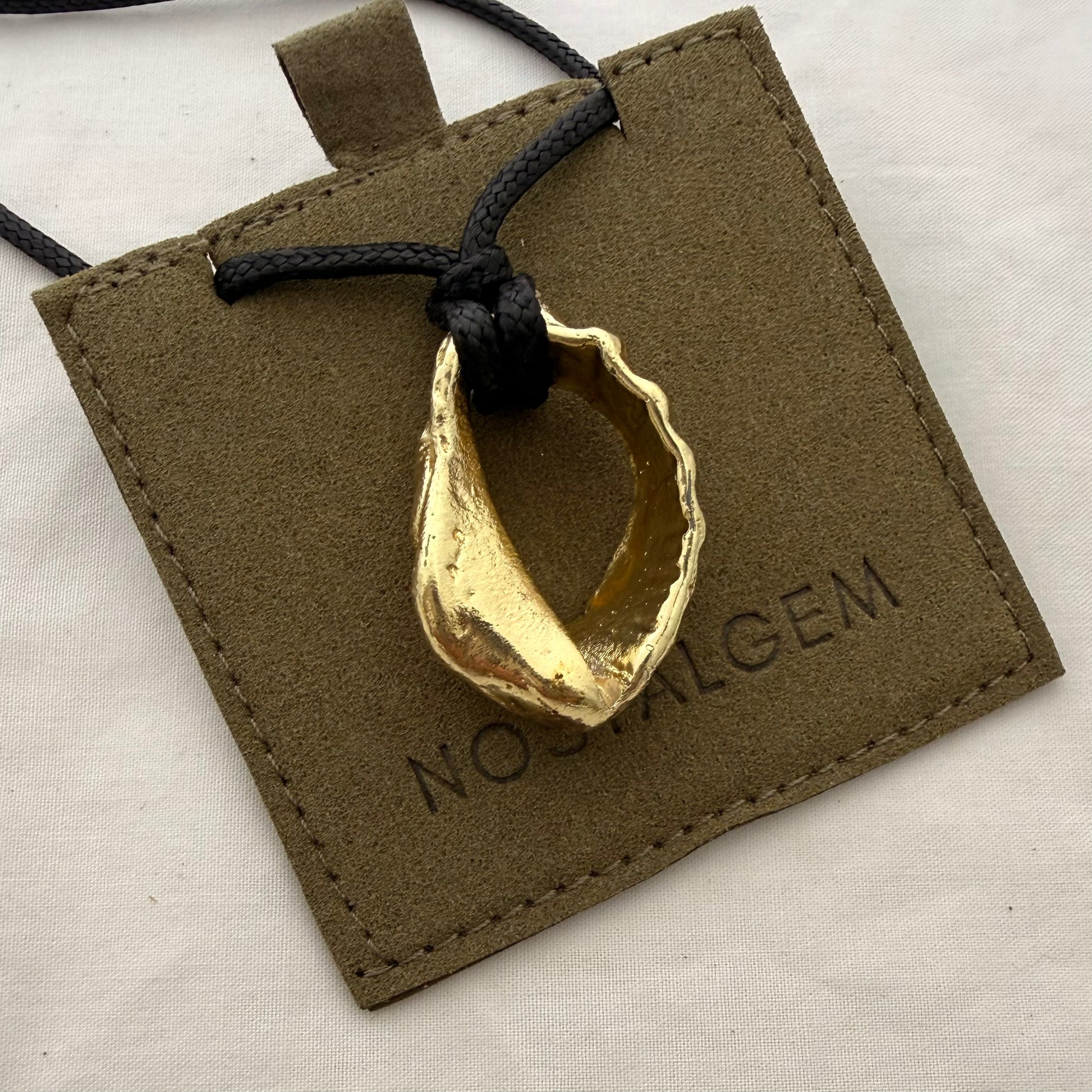 Gold whelk shell cord necklace styled shot